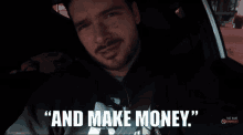 a man sitting in a car with the words " and make money " on the screen