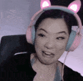 a woman wearing pink headphones with cat ears