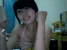 a woman with a bracelet on her wrist smiles in front of a mirror
