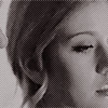 a woman 's face is shown in a black and white photo