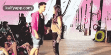 a man and a woman are standing next to each other on a stage .