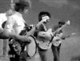 a black and white photo of a band with the number 1128-2 in the corner