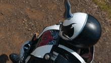 a person wearing a black and white helmet with the number 25 on the back of it