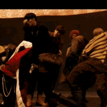 a group of people are dancing and one of them is wearing a red shirt