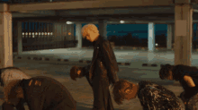 a group of young men are dancing on a street