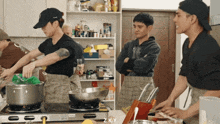 a group of men are cooking in a kitchen with z ky written on the bottom right