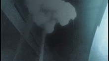 a dark room with smoke coming out of the corner