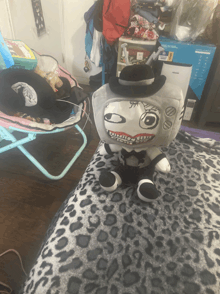 a stuffed animal is sitting on a leopard print bed