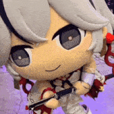 a close up of a stuffed toy with a gun
