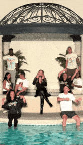 a group of people posing for a picture with one wearing a t-shirt that says miami
