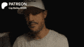 a man in a white hat is holding a glass with the words " patreon cap bailey asmr " on the bottom right