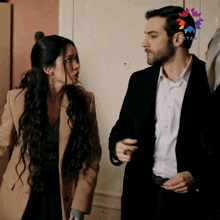 a man and a woman are standing next to each other with a star on their ear
