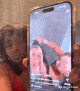 a man is holding a cell phone with a picture of a woman taking a selfie .