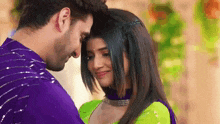 a man and a woman are looking at each other and smiling .