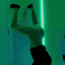a person is doing a handstand in a room