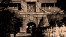 a black and white photo of soldiers in front of a large building