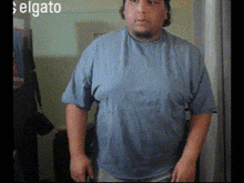 a man in a blue shirt is standing in front of a sign that says elgato on it