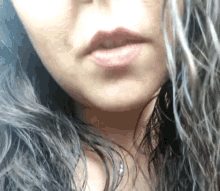 a close up of a woman 's lips with a gray fringe