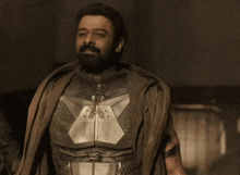 a man with a beard is wearing a superhero armor