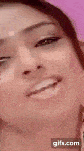 a close up of a woman 's face with a gifs.com icon in the corner