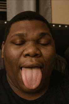 a man with his eyes closed and his tongue hanging out