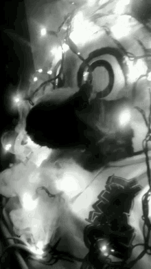 a black and white photo of a christmas tree with lights on it