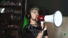 a man wearing headphones is holding a megaphone with the word japan on it
