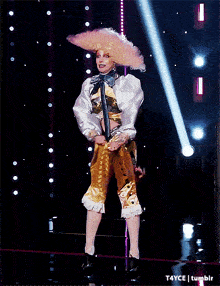 a woman in a wig is dancing on a stage with the words t4yce tumblr in the corner