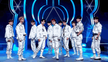 a group of young men are standing in front of a blue background with the word joy on it