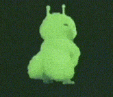 a green cartoon character is dancing on a black background