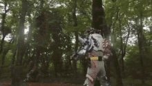 a man in a robot costume is standing in the woods with the words `` one side '' written on the bottom .