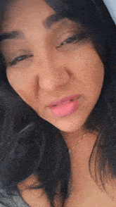 a close up of a woman 's face with pink lipstick