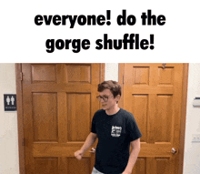 a man in a black shirt is standing in front of a wooden door with the words everyone do the gorge shuffle