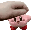 a person is petting a stuffed kirby star .