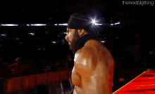 a man with a beard is standing in front of a screen that says smackdown live