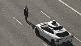 a white car with a black and white object on top