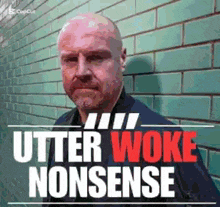 a bald man is standing in front of a green brick wall with the words utter woke nonsense written on it
