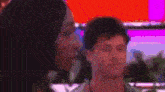 a man and a woman are standing next to each other in a room .