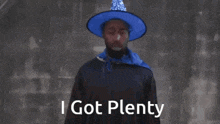 a man wearing a blue hat and a blue scarf says i got plenty