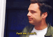 a man is saying " fuck me i can 't " while standing in front of a blue wall .