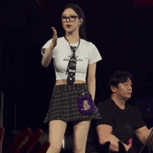 a woman wearing glasses and a shirt that says monsters on it