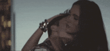 a woman is touching a man 's neck in a blurry photo