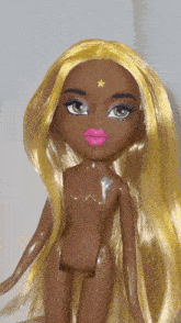 a naked doll with a star on her forehead and pink lips