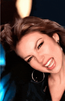 a close up of a woman 's face with a smile on her face
