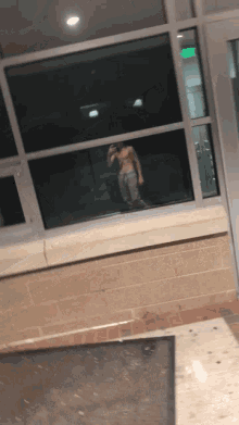 a man without a shirt is taking a picture of himself in a mirror