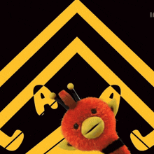 two stuffed animals are standing in front of a yellow and black sign that says a