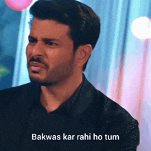 a man in a black suit with the words " bakwas kar rahi ho tum " on the bottom