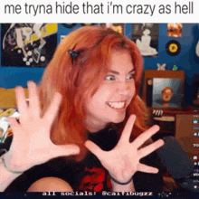 a girl with red hair is making a funny face with the caption me tryna hide that i m crazy as hell