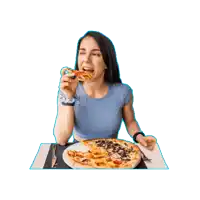 a woman is sitting at a table eating pizza