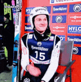 a man wearing a gorenje helmet and a benedikliner 15 jersey
